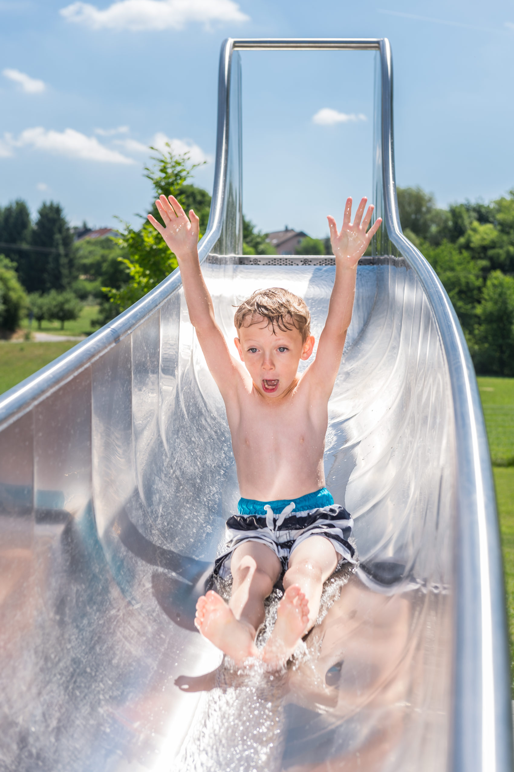 Child on water slide atlantics stainless steel slides open air swimming pool flehingen oberthedingen bathroomen wuerttemberg pool 168105