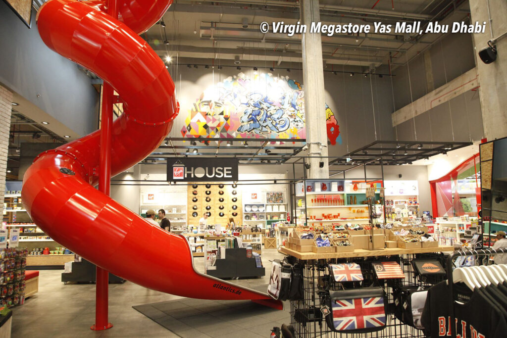 Rote Edelstahlrutsche, indoor Tunnelrutsche im Virgin Megastore in der Yas Mall in Abu Dhabi, Vereinigte Arabische Emirate, Rutsche im Shopping Center