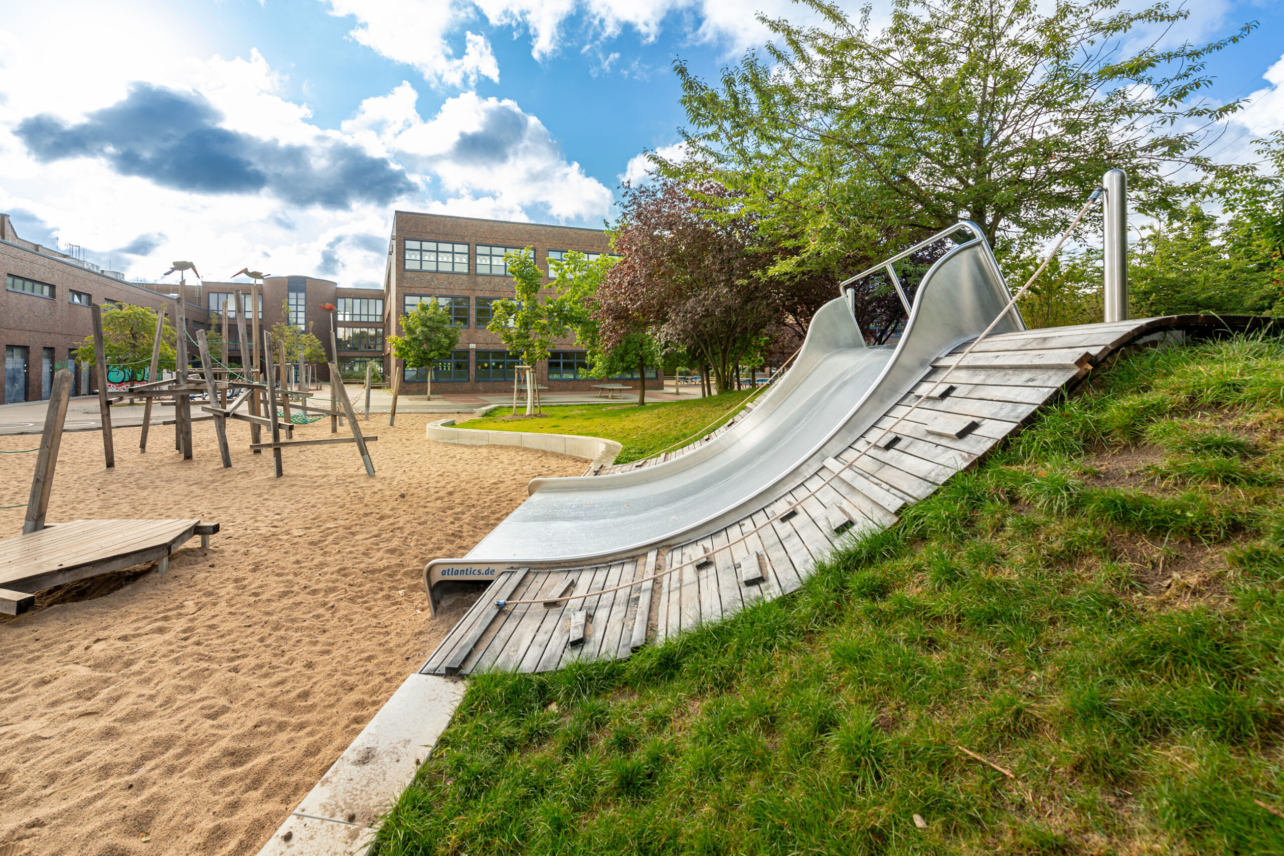 atlantics Breitrutsche aus Edelstahl an der Kolibri Grundschule in Berlin, Kastenrutsche, Edelstahlrutsche, Hangrutsche
