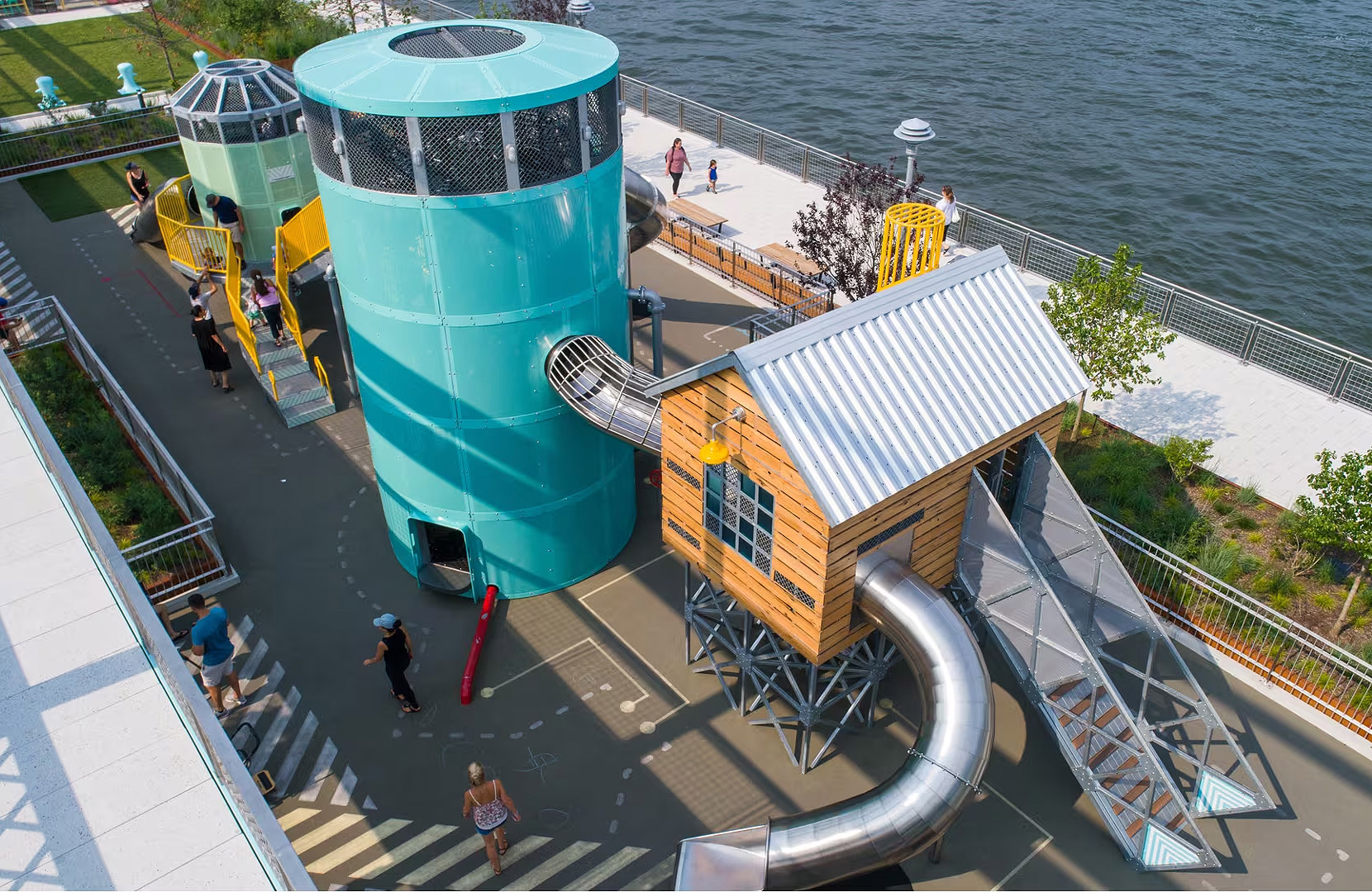 atlantics stainless steel slides on a play structure at a Playground in Brooklyn on the East River, New York City, USA